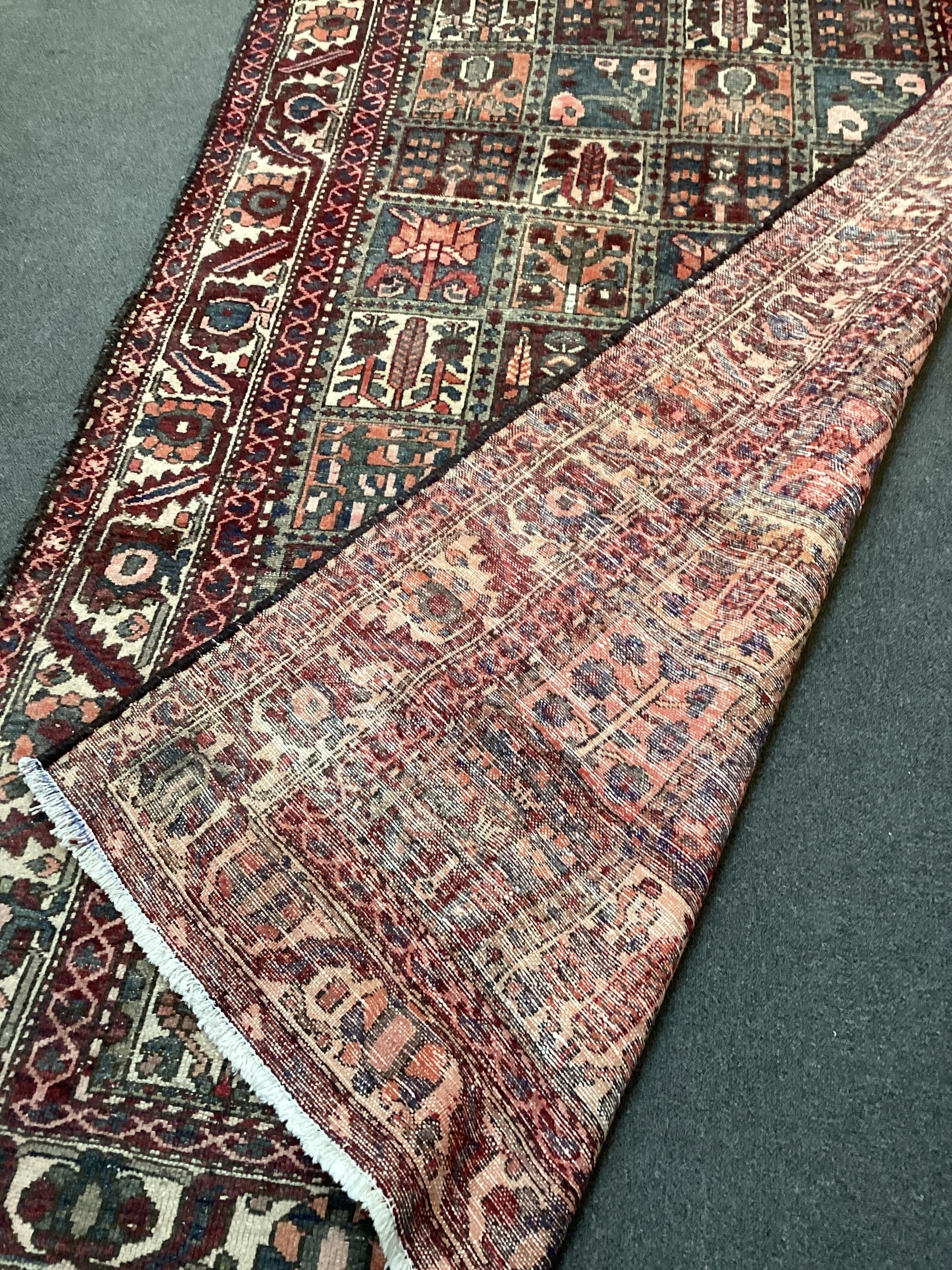 A Baktiari carpet woven panels of floral devices, 300cm x 156cm